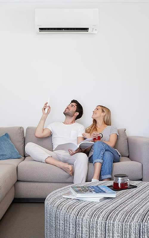 Man Using Remote For Diakin Ductless Ac Unit On Wall (1)