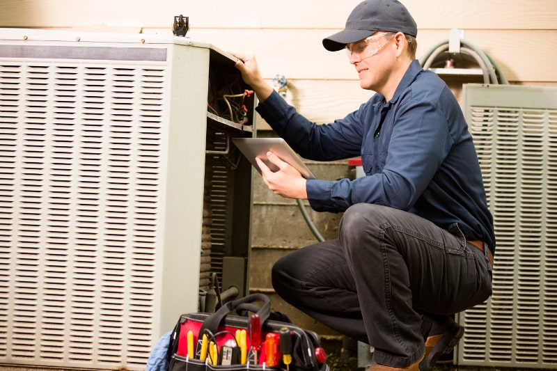 technician checking heat pump