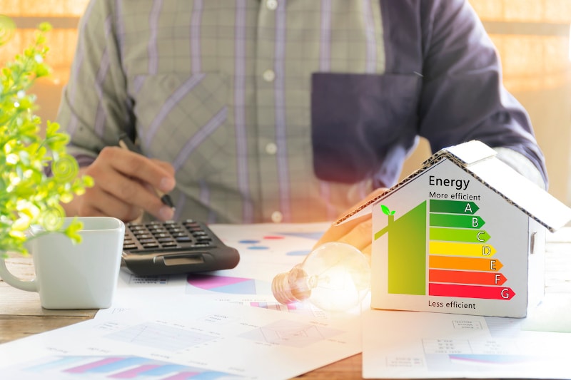 Man Doing Calculations To Make His Home More Energy Efficient