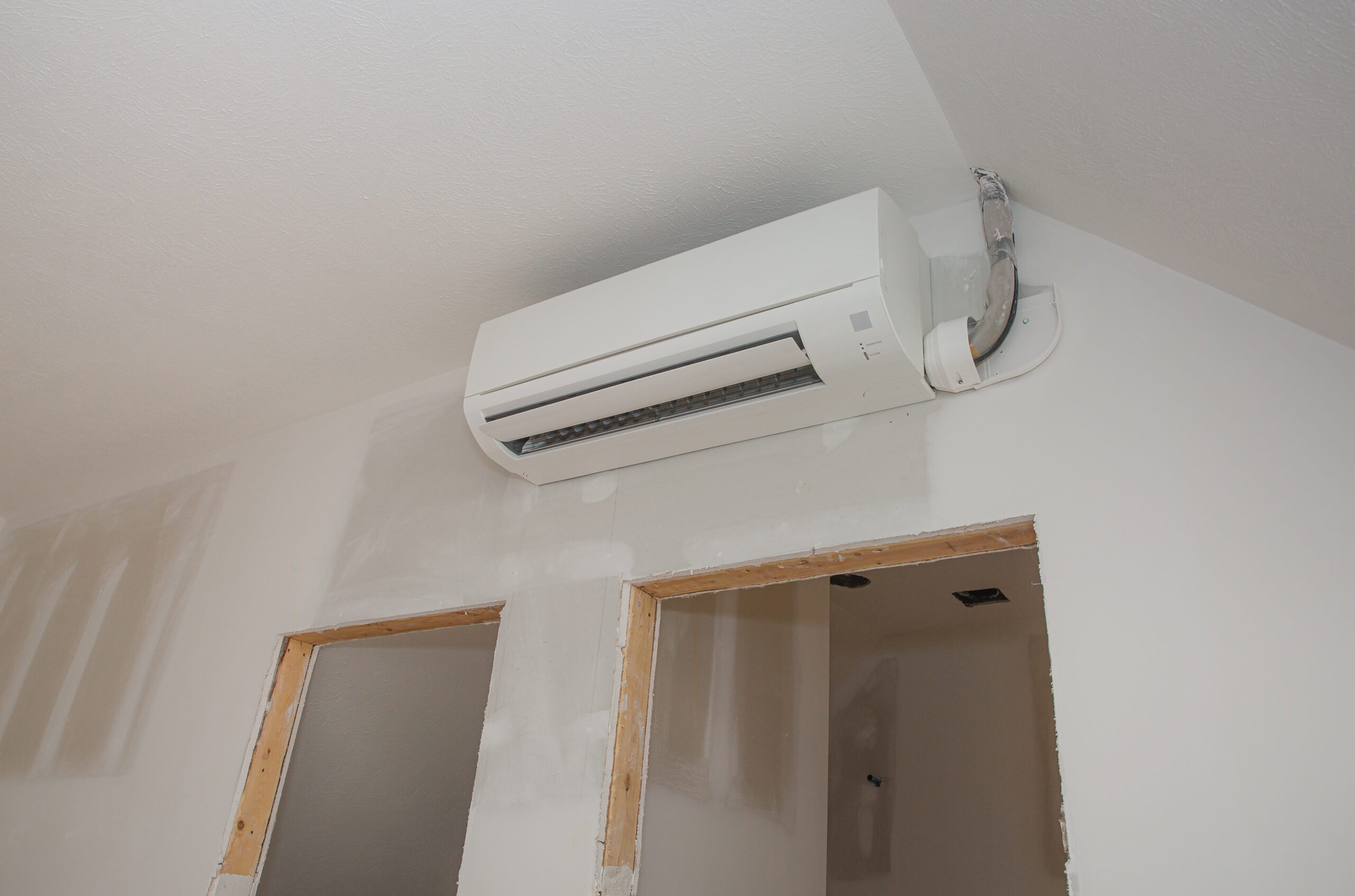 Mini Split Ductless Air Conditioning Unit Installed In Unfinished Room